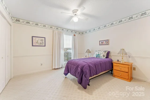 a spacious bedroom with a bed and a chandelier