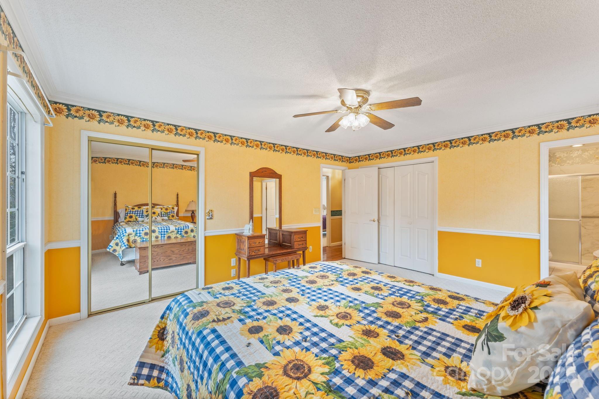 184 Trimont Mountain Road Franklin, NC 28734 - Photo 20 of 41 a bedroom with a bed and a chandelier