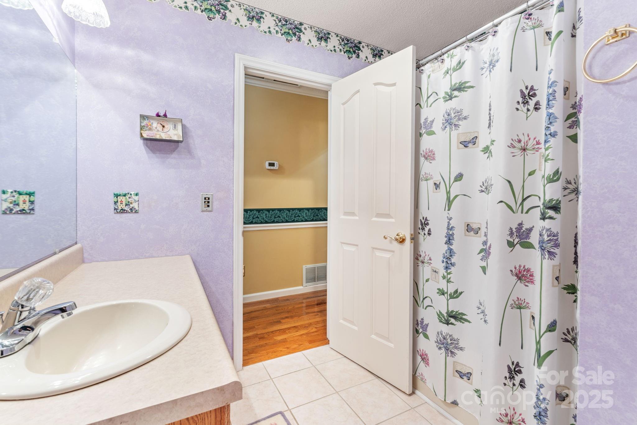 184 Trimont Mountain Road Franklin, NC 28734 - Photo 25 of 41 a bathroom with a sink and a mirror