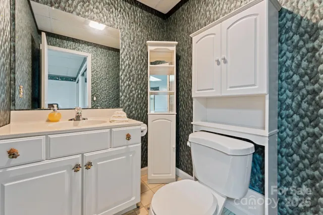 a bathroom with a toilet sink and mirror