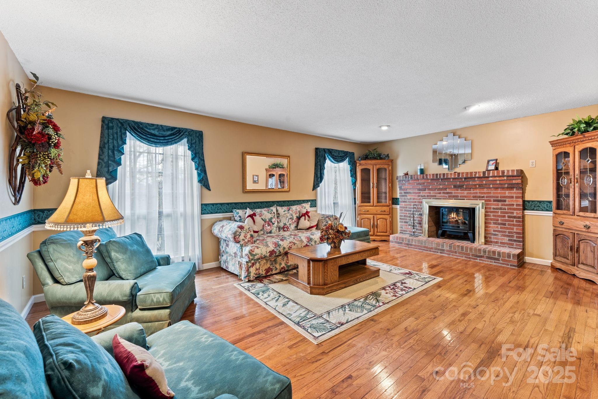 184 Trimont Mountain Road Franklin, NC 28734 - Photo 4 of 41 a living room with furniture a flat screen tv and a fireplace