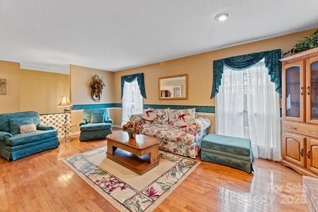 a living room with furniture rug and lamp