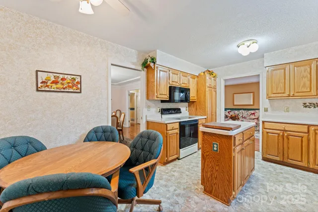 a bedroom with stainless steel appliances a bed and cabinets