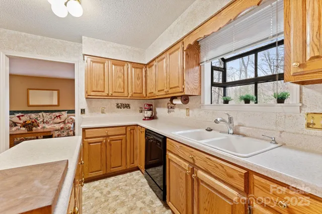 a kitchen with a sink stove and cabinets