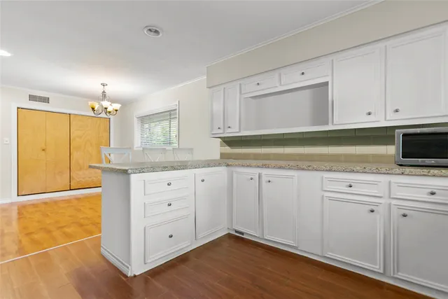 a kitchen with granite countertop stainless steel appliances a refrigerator sink and microwave