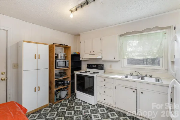 a kitchen with a stove a sink and a refrigerator