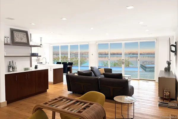 a living room with furniture a large window and wooden floor