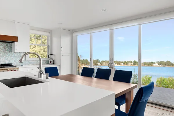 a large white kitchen with a large window