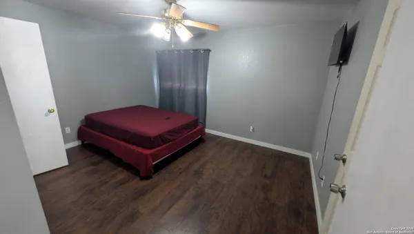 a room with a bed and wooden floor