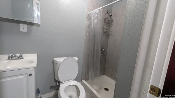 a bathroom with a toilet and a sink