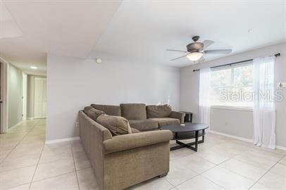 2360 Southwest Archer Road, Unit 506 Gainesville, FL 32608 - Photo 3 of 9 a living room with furniture and a chandelier