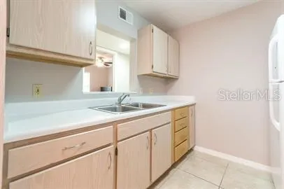 a utility room with cabinets washer and dryer