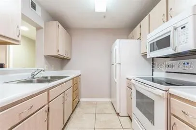 a kitchen with stainless steel appliances granite countertop a sink and a stove top oven