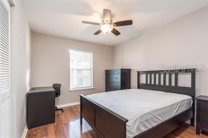 2360 Southwest Archer Road, Unit 506 Gainesville, FL 32608 - Photo 7 of 9 a bedroom with a large bed and a chandelier