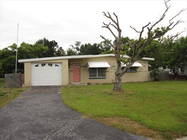 5211 Hemlock Drive New Port Richey, FL 34652 - Photo 1 of 1 a front view of a house with garden