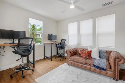 a living room with furniture gym equipment and a rug