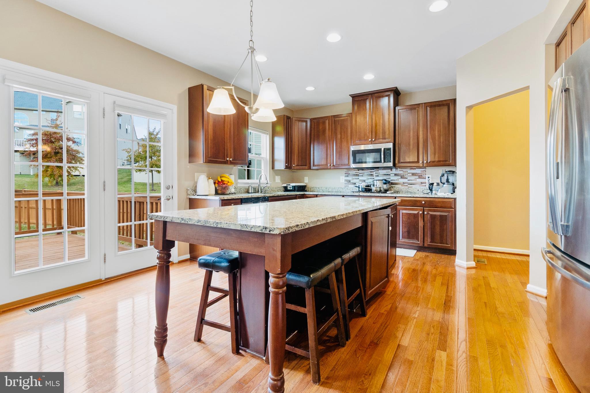 3214 Fledgling Circle Woodbridge, VA 22193 - Photo 16 of 30 a kitchen with stainless steel appliances granite countertop a stove a sink dishwasher and a refrigerator with wooden floor