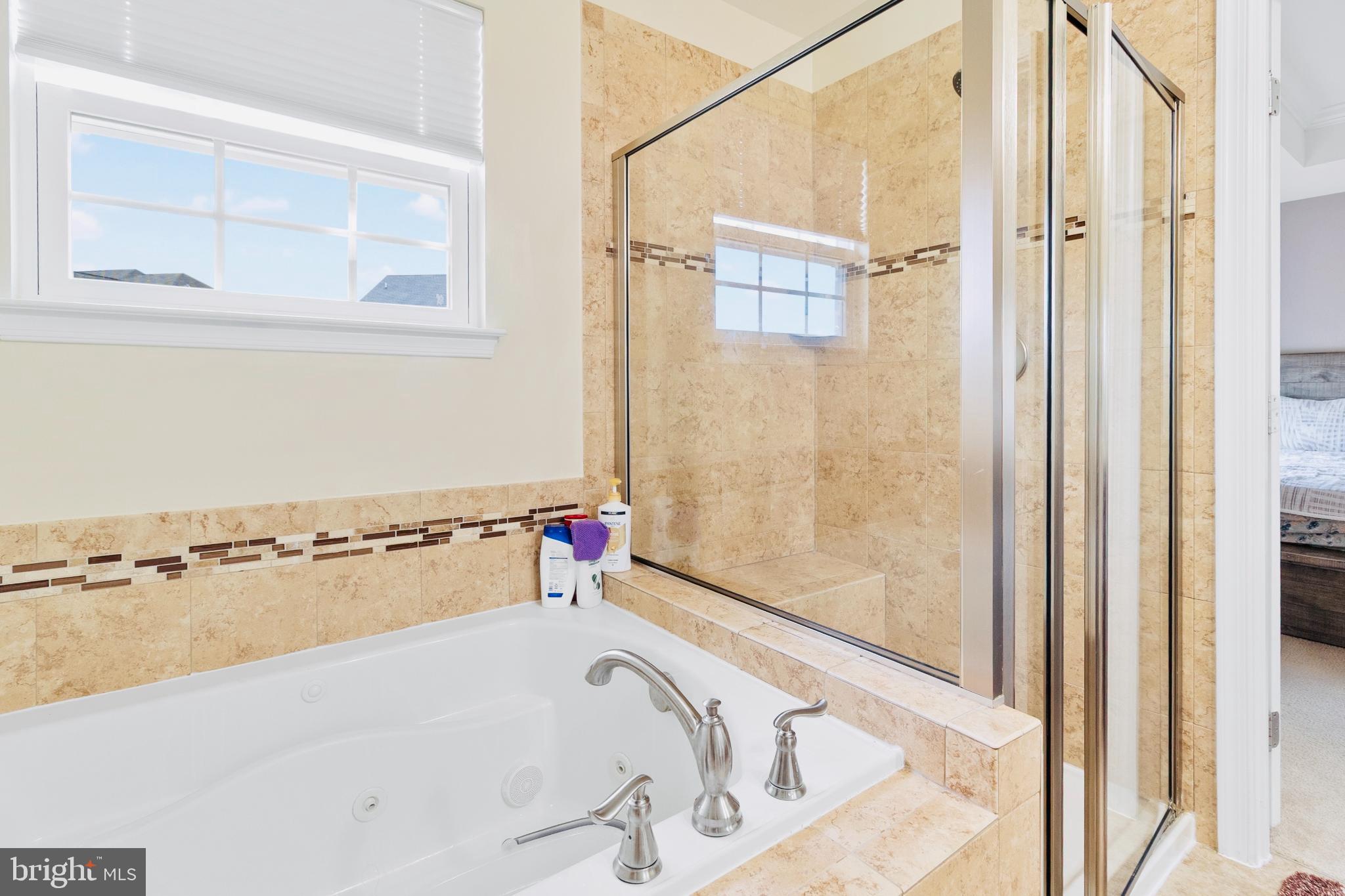 3214 Fledgling Circle Woodbridge, VA 22193 - Photo 23 of 30 a bathroom with a bathtub and a shower