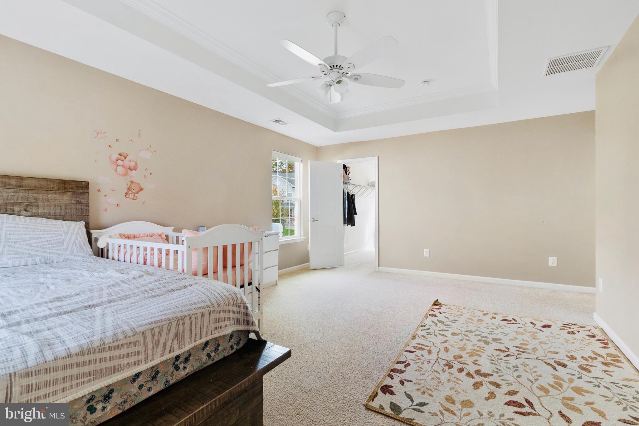 3214 Fledgling Circle Woodbridge, VA 22193 - Photo 25 of 30 a bedroom with a bed and a chandelier