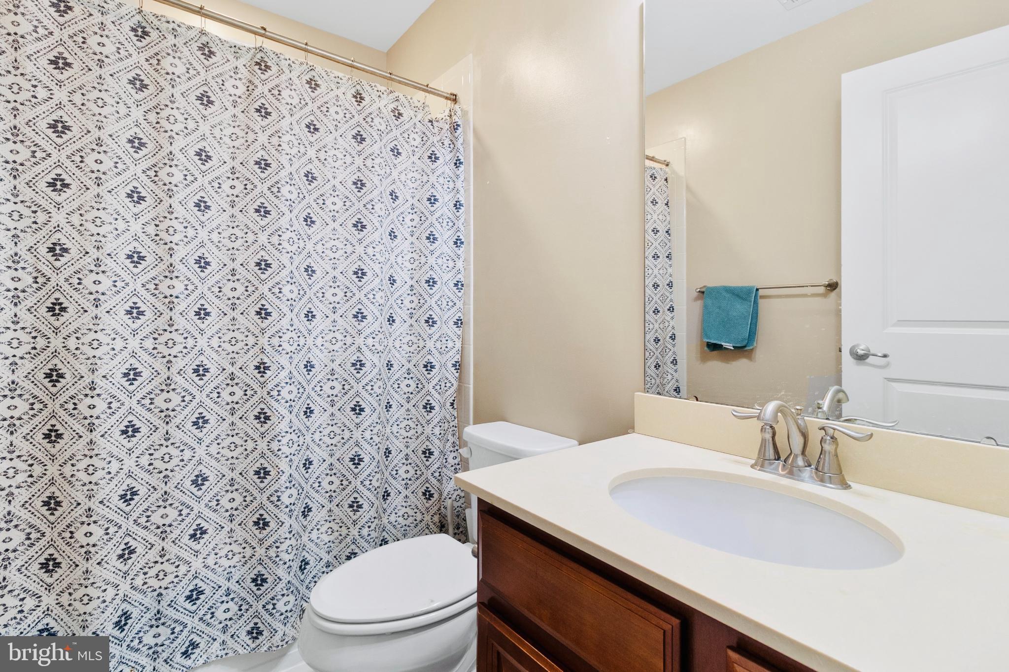 3214 Fledgling Circle Woodbridge, VA 22193 - Photo 28 of 30 a bathroom with a granite countertop toilet sink and mirror