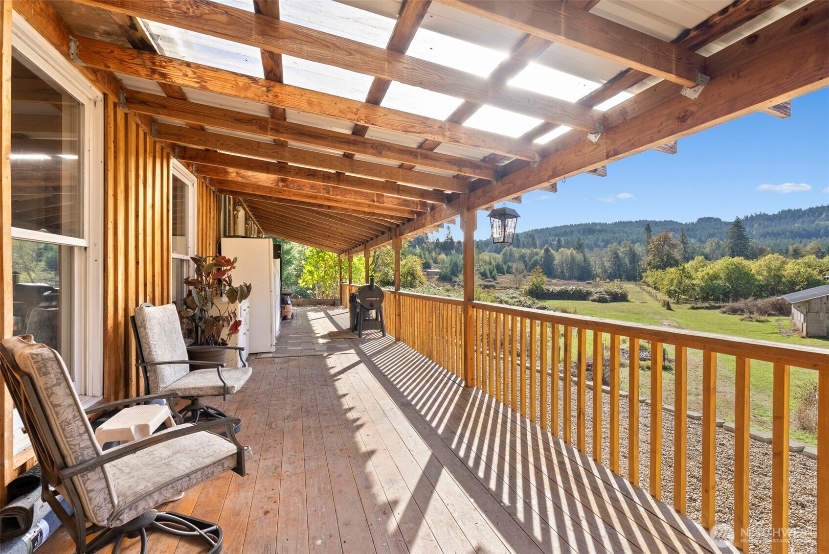 259-10 Tooley Road Toledo, WA 98591 - Photo 5 of 40 a view of a balcony with couch and wooden floor