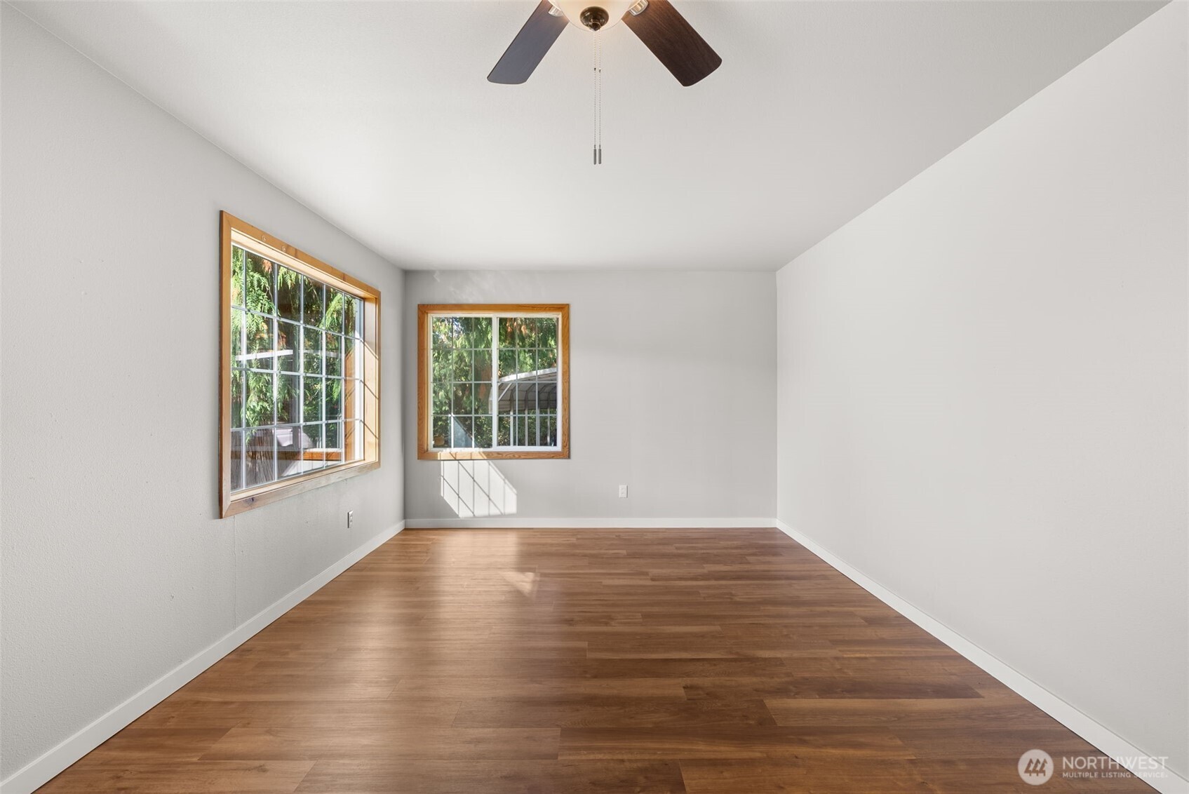 259-10 Tooley Road Toledo, WA 98591 - Photo 8 of 40 a view of an empty room with window and wooden floor