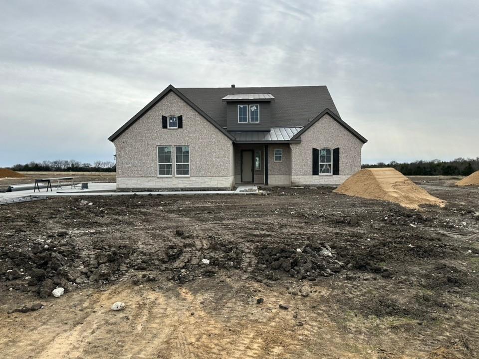 View of front of property with a standing seam roof and a metal roof