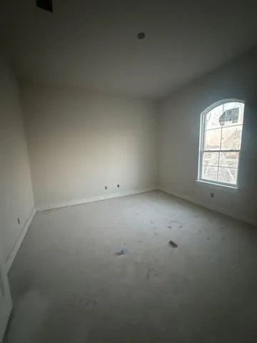 a view of an empty room with floor to ceiling windows