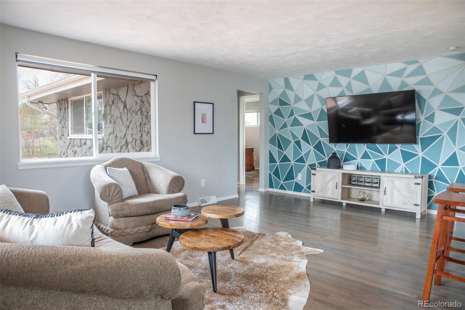 5380 Easley Road Golden, CO 80403 - Photo 12 of 38 a living room with furniture a flat screen tv and a large window