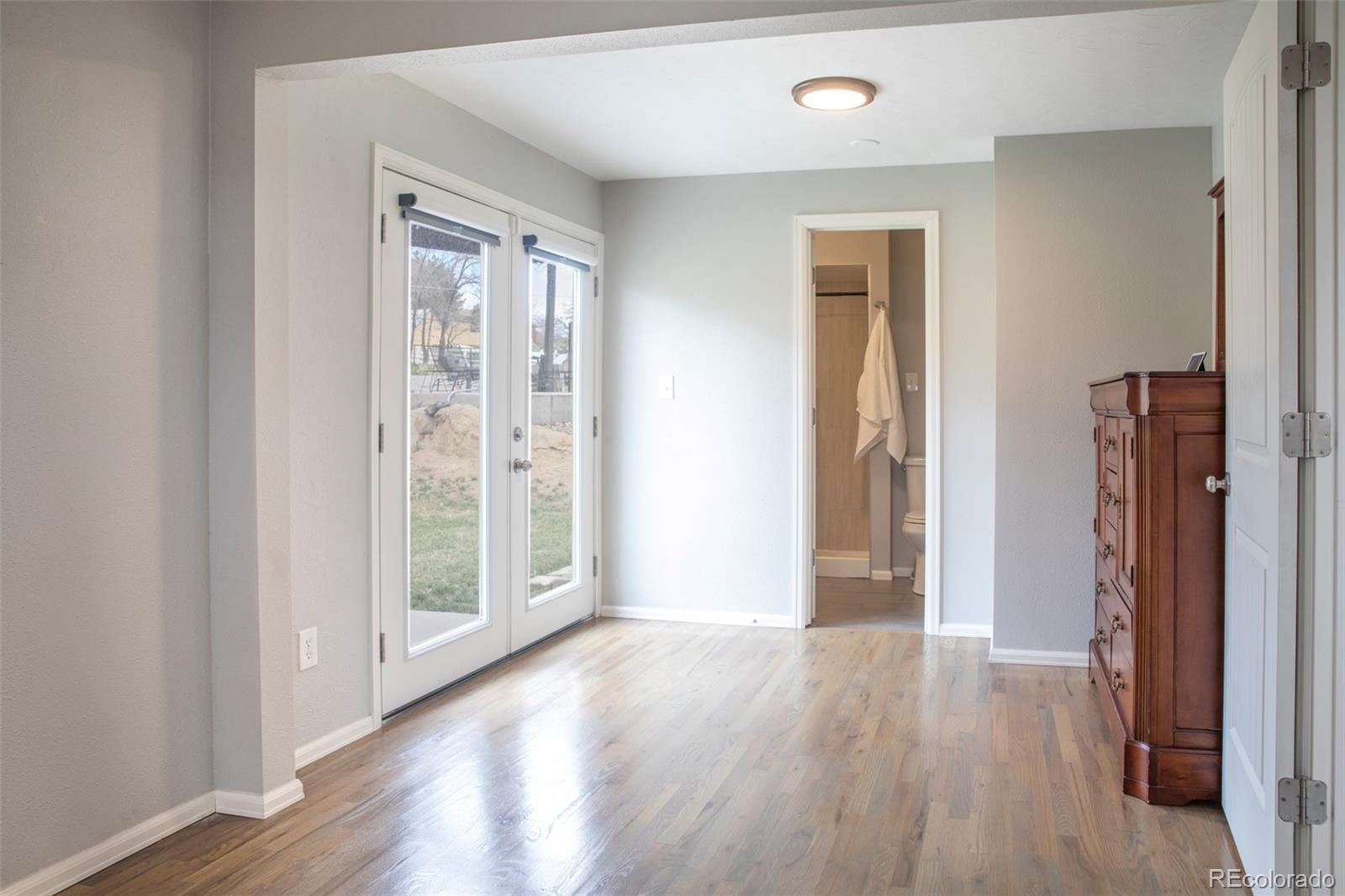 5380 Easley Road Golden, CO 80403 - Photo 21 of 38 an empty room with wooden floor and windows