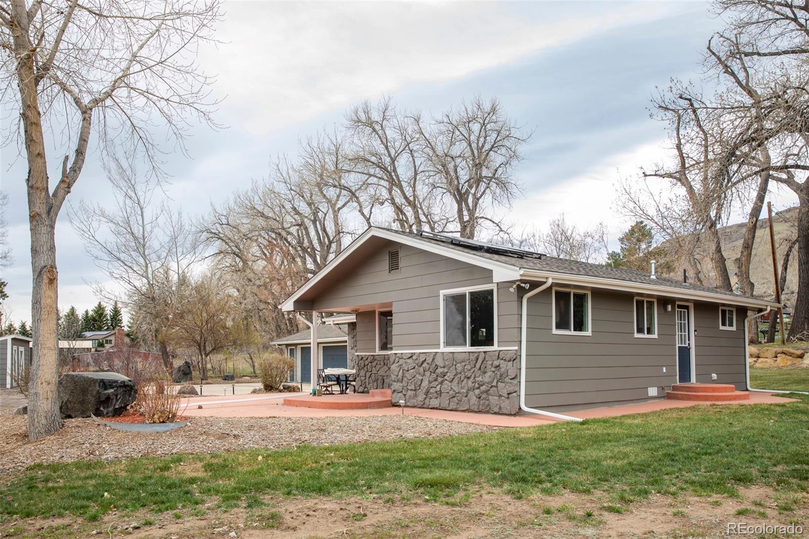5380 Easley Road Golden, CO 80403 - Photo 3 of 38 a front view of a house with yard and garage