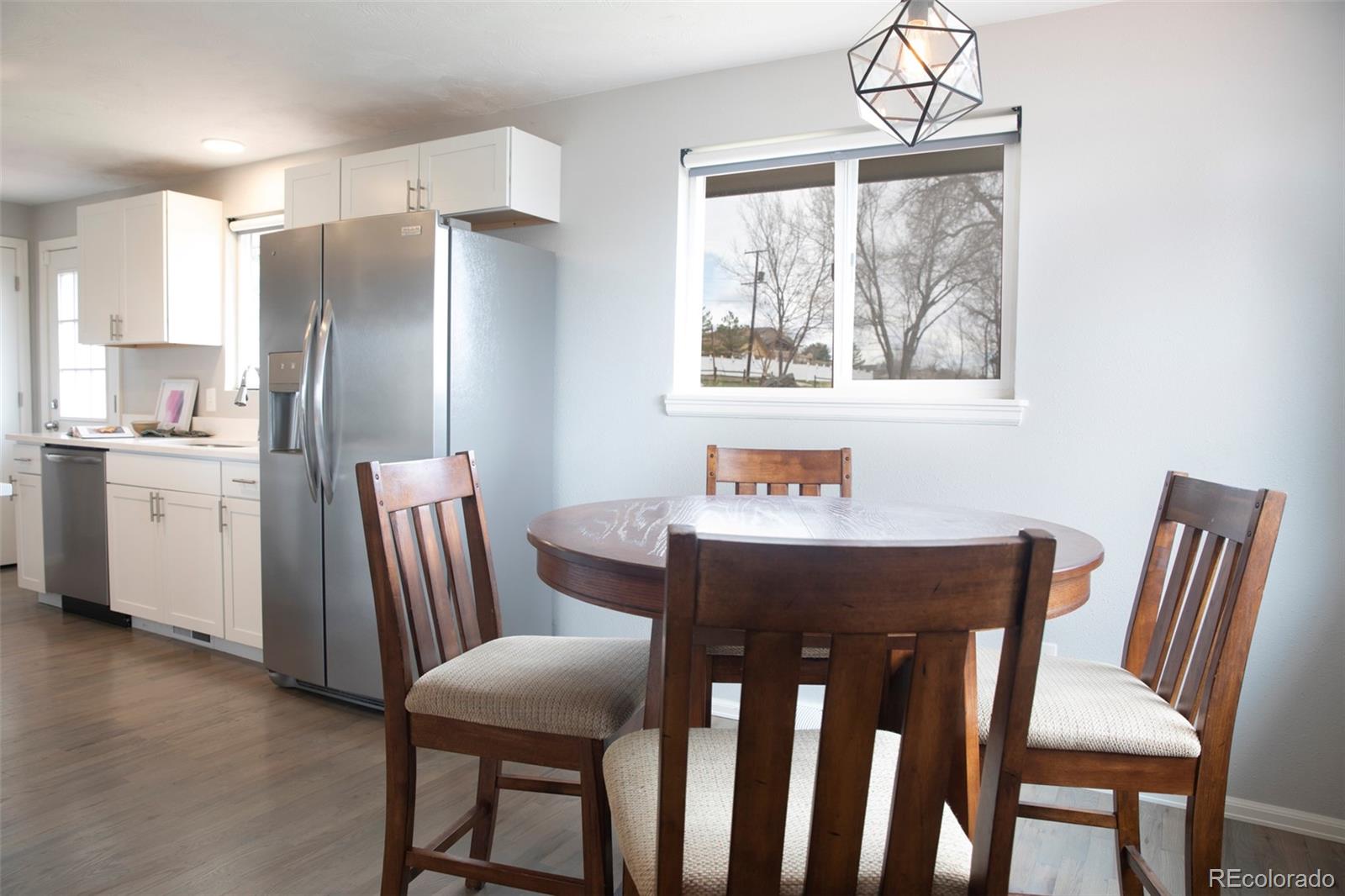 5380 Easley Road Golden, CO 80403 - Photo 5 of 38 a kitchen with stainless steel appliances granite countertop a dining table chairs and a refrigerator