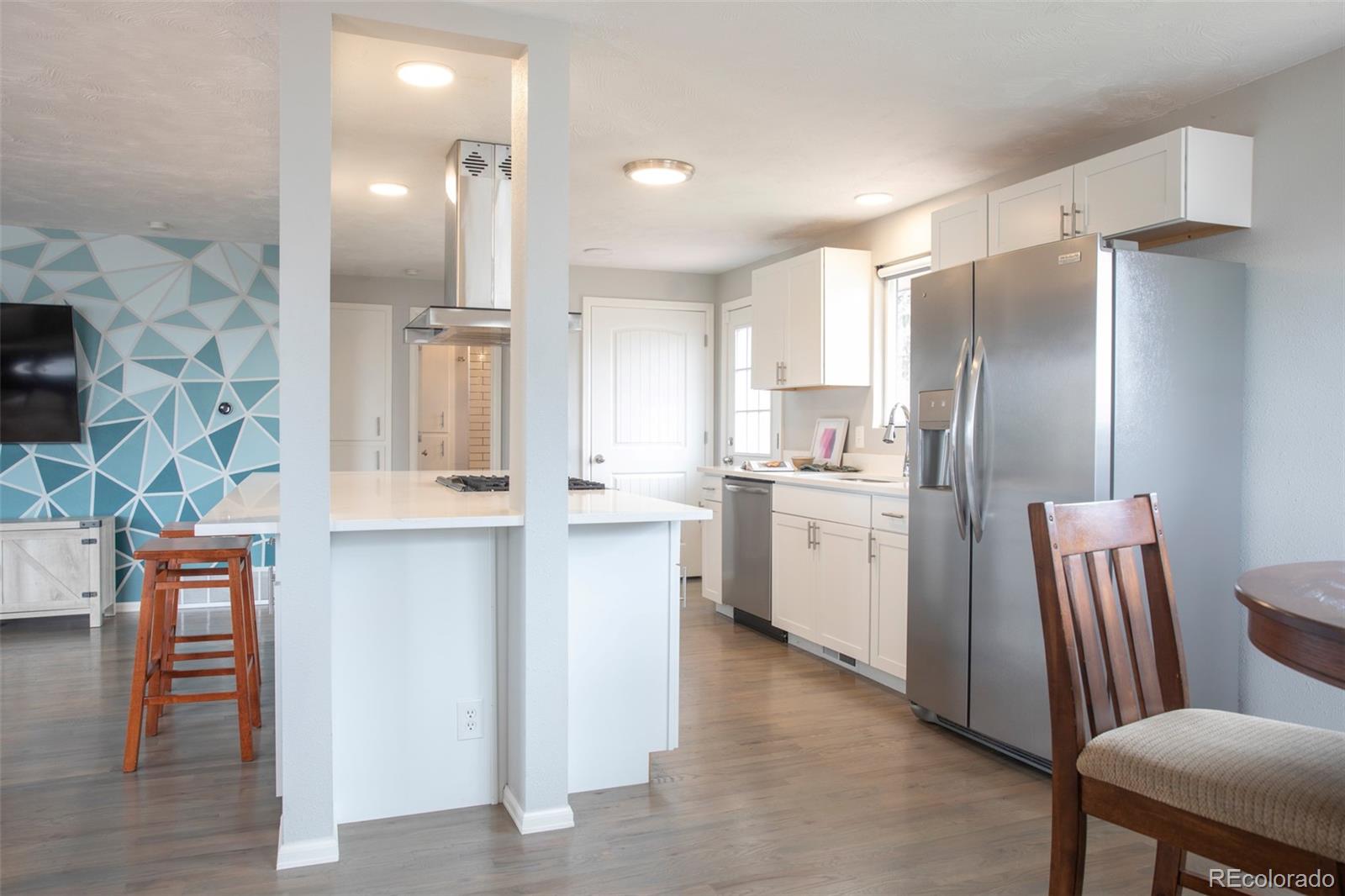 5380 Easley Road Golden, CO 80403 - Photo 6 of 38 a kitchen with stainless steel appliances granite countertop a refrigerator a stove and a wooden floors