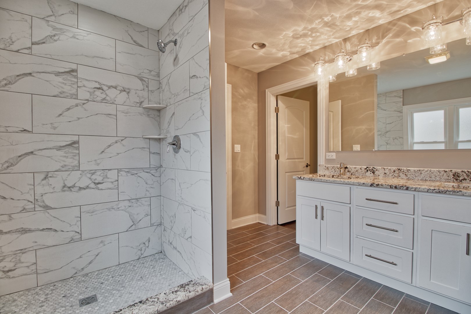 747 Arlington Road Riverside, IL 60546 - Photo 11 of 16 a bathroom with a granite countertop sink a mirror and a shower
