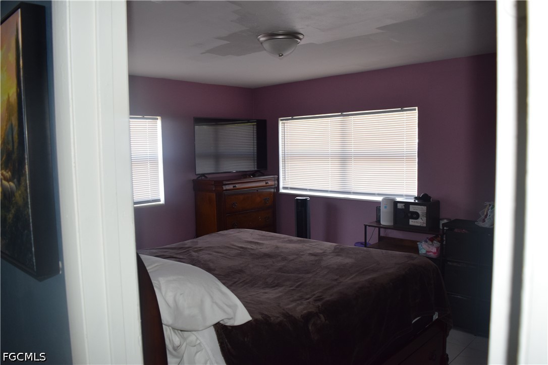 17 Colorado Road Lehigh Acres, FL 33936 - Photo 11 of 17 a bedroom with a bed and a window