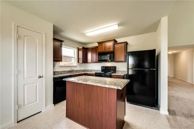a kitchen with a refrigerator stove and a sink