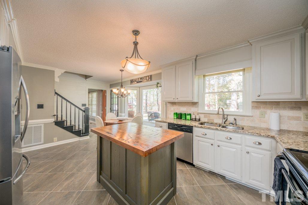 6108 Wolverhampton Drive Raleigh, NC 27603 - Photo 11 of 30 a kitchen with sink cabinets and window