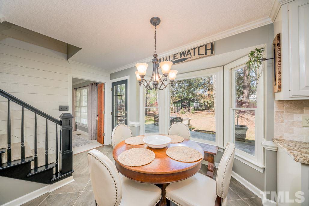 6108 Wolverhampton Drive Raleigh, NC 27603 - Photo 12 of 30 a view of a dining room with furniture window and wooden floor