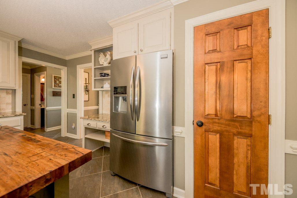 6108 Wolverhampton Drive Raleigh, NC 27603 - Photo 15 of 30 a kitchen with stainless steel appliances refrigerator stove and cabinets