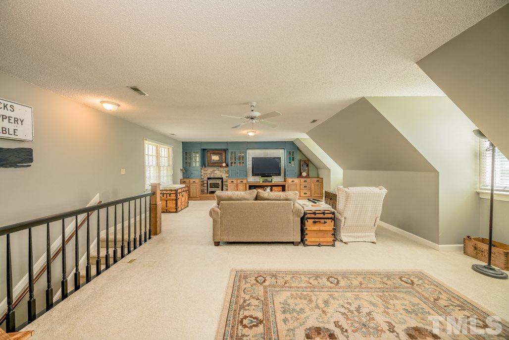 6108 Wolverhampton Drive Raleigh, NC 27603 - Photo 19 of 30 a living room with furniture and a wooden floor