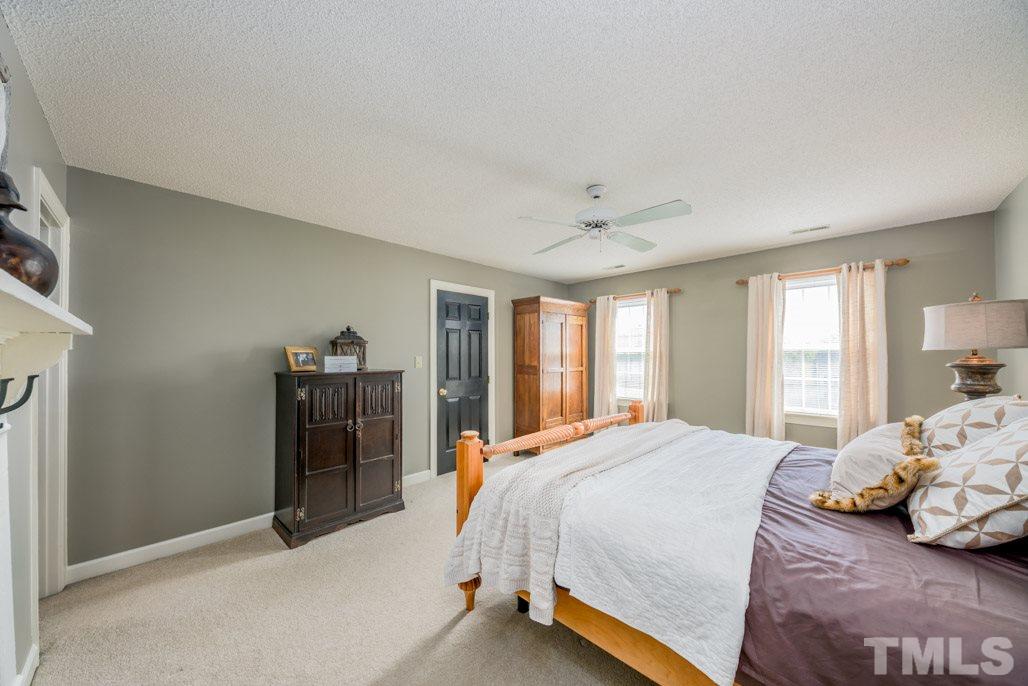 6108 Wolverhampton Drive Raleigh, NC 27603 - Photo 21 of 30 a bedroom with a bed and a window