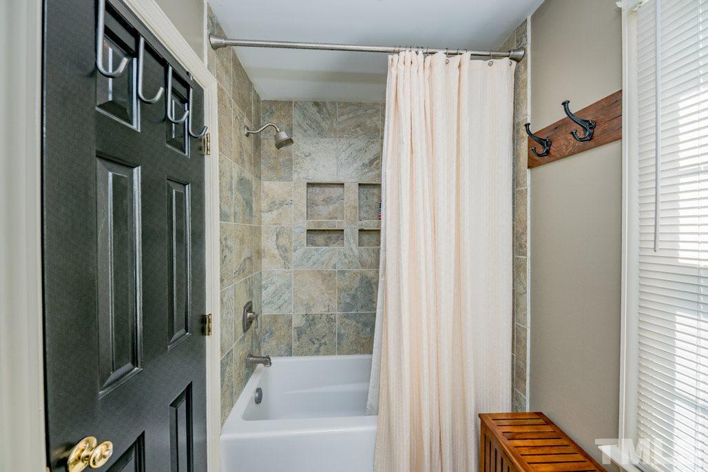 6108 Wolverhampton Drive Raleigh, NC 27603 - Photo 25 of 30 a bathroom with a bathtub and a shower