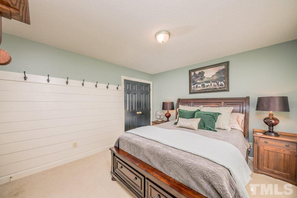 6108 Wolverhampton Drive Raleigh, NC 27603 - Photo 26 of 30 a bedroom with a bed and a cabinets