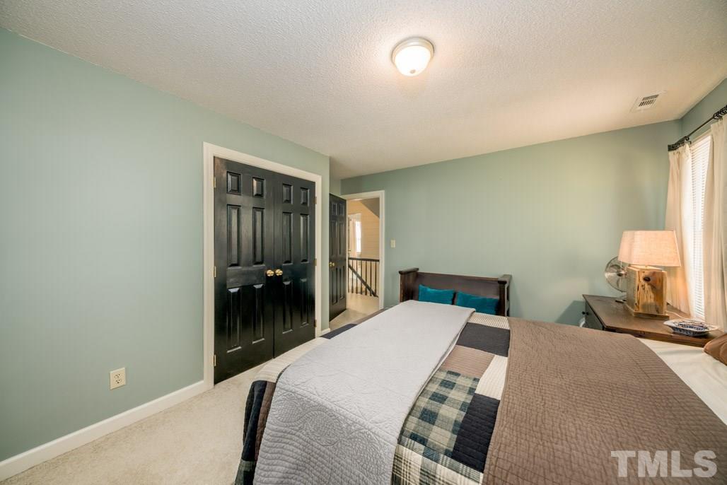 6108 Wolverhampton Drive Raleigh, NC 27603 - Photo 29 of 30 a bedroom with a bed and a lamp