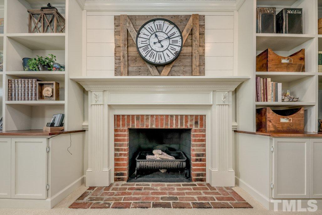 6108 Wolverhampton Drive Raleigh, NC 27603 - Photo 8 of 30 a living room with a fireplace and a table