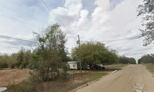 a view of a street with houses on both side