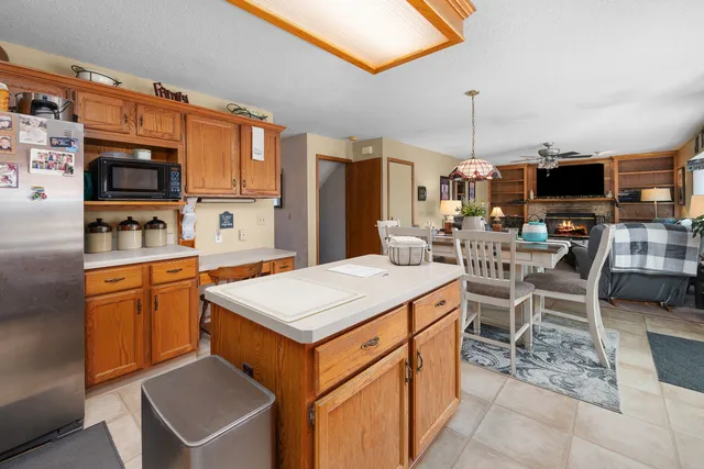 a large kitchen with stainless steel appliances granite countertop a stove top oven a sink dishwasher and cabinets with wooden floor