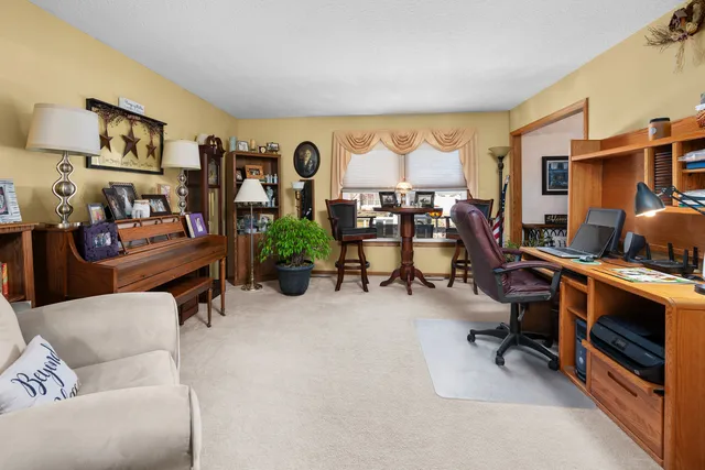 a view of a livingroom with workspace and a window