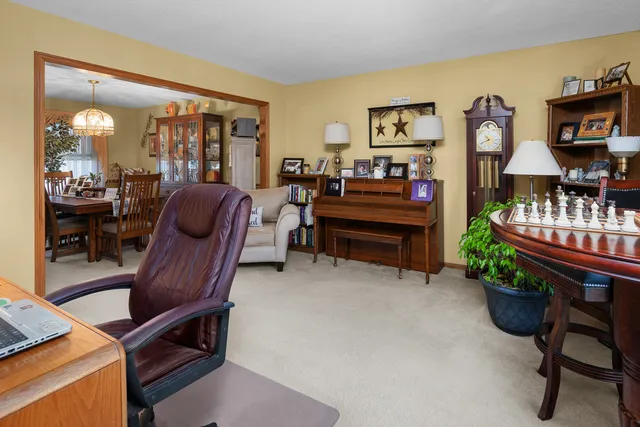 a dining room with furniture and a chandelier