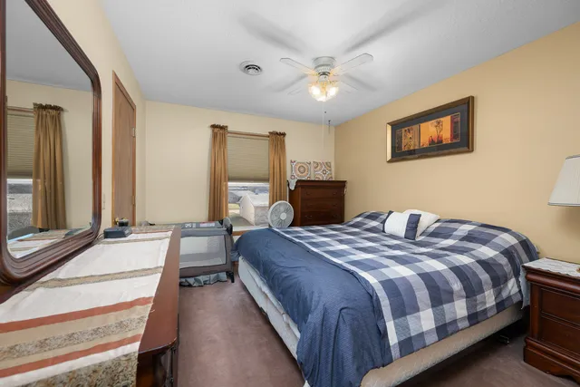 a bedroom with a bed and a dresser